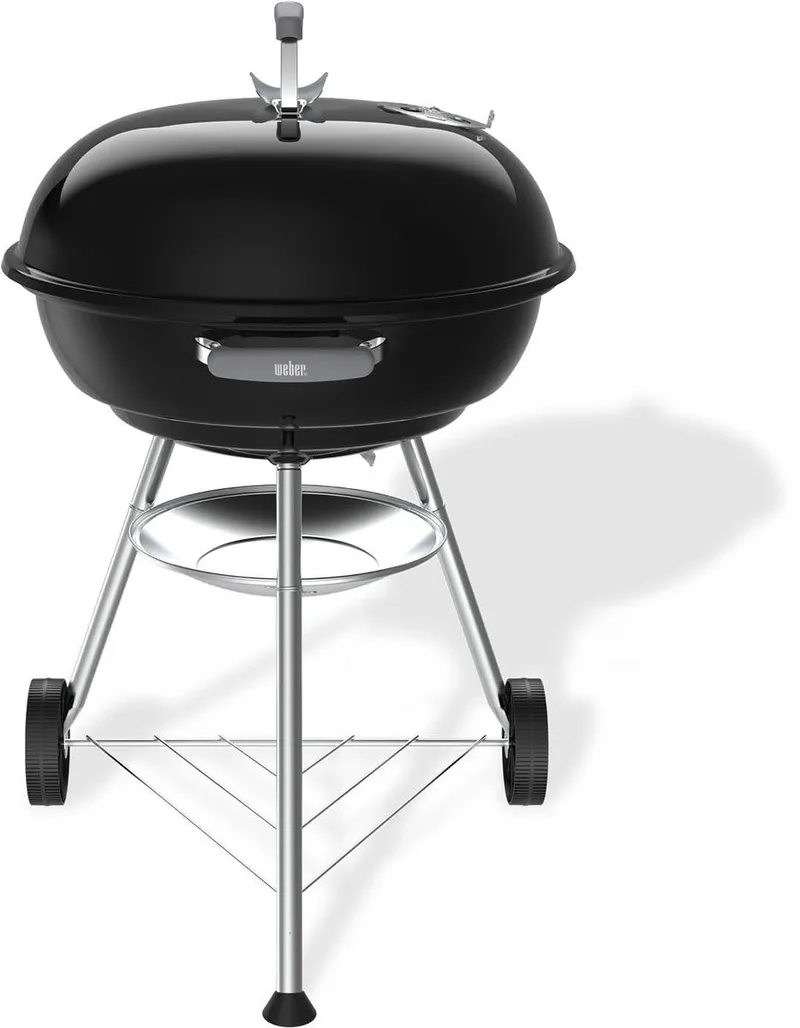 Compact Kettle - Ø 57 cm Grillrooster - Houtskoolbarbecue - Asopvangschaal - 2 Duurzame, weerbestendige wielen - Handige dekselhaak - Kras- en roestbestendig by Weber in Black – product photo